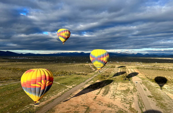 Photo of hot air balloons rising in the desert